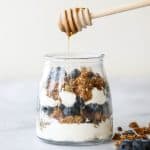 Layer fresh fruits, creamy Greek yogurt and crunchy granola to make this fruit and yogurt parfait for a delicious and healthy breakfast or a simple snack. | aheadofthyme.com