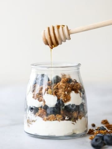 Layer fresh fruits, creamy Greek yogurt and crunchy granola to make this fruit and yogurt parfait for a delicious and healthy breakfast or a simple snack. | aheadofthyme.com