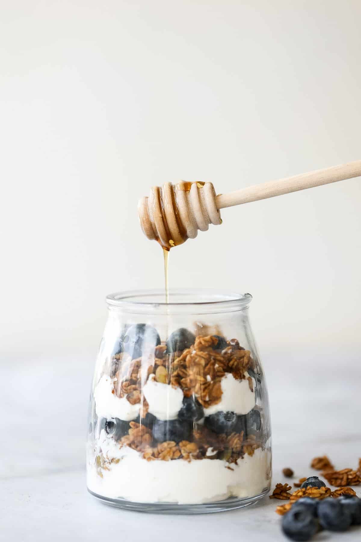 Layer fresh fruits, creamy Greek yogurt and crunchy granola to make this fruit and yogurt parfait for a delicious and healthy breakfast or a simple snack. | aheadofthyme.com