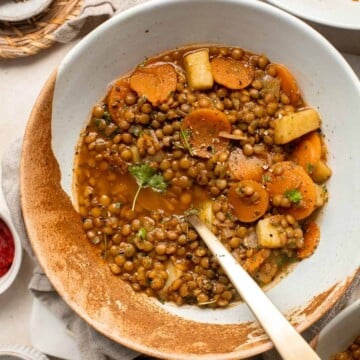 Lentil Stew is a hearty and filling vegan meal loaded with vegetables like carrots and potatoes. This well seasoned vegetarian stew is ready in 45 minutes. | aheadofthyme.com