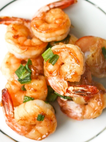 Quick and easy, pan-fried garlic prawns with soy sauce, garlic, and green onions is a simple but flavourful Chinese stir-fry made in under 15 minutes. | aheadofthyme.com