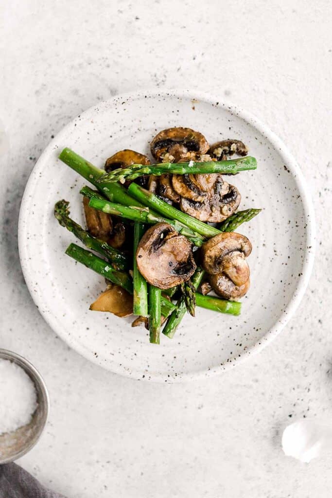 Roasted garlic asparagus and mushrooms is a simple vegan sheet pan side dish that‘s easy to make, flavorful and delicious. Serve with your favorite protein. | aheadofthyme.com