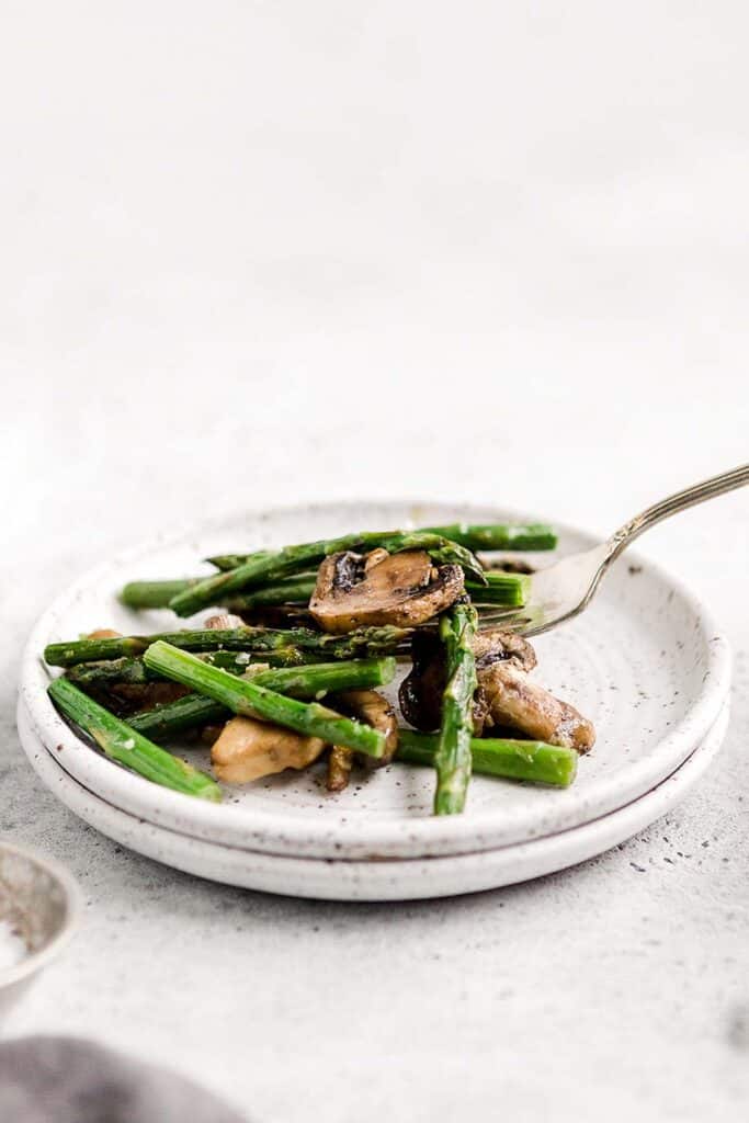 Roasted garlic asparagus and mushrooms is a simple vegan sheet pan side dish that‘s easy to make, flavorful and delicious. Serve with your favorite protein. | aheadofthyme.com