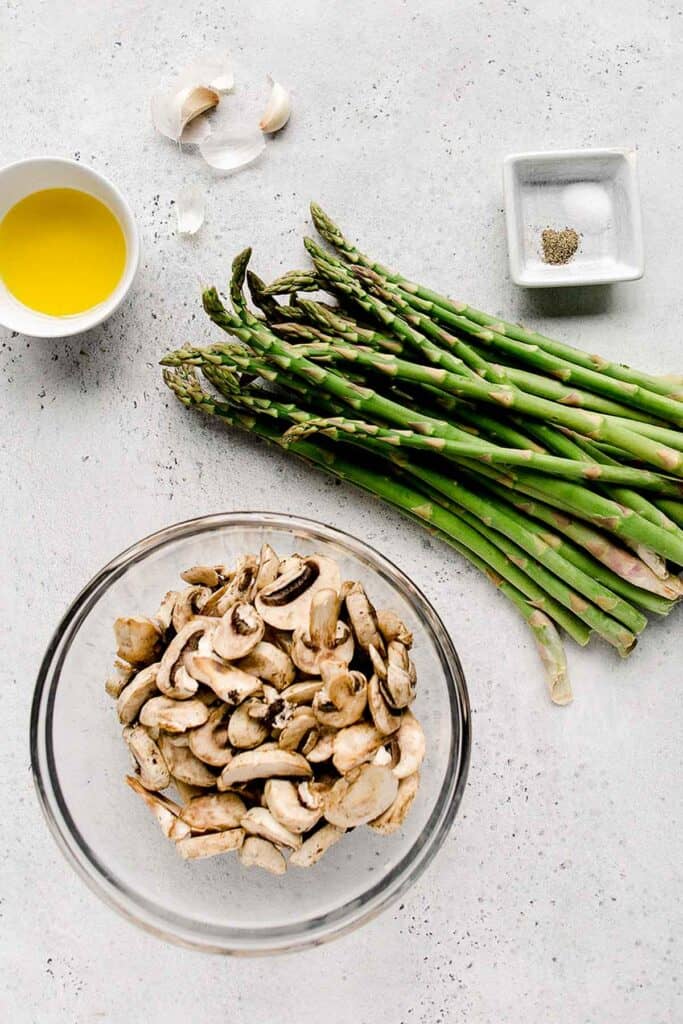 Roasted garlic asparagus and mushrooms is a simple vegan sheet pan side dish that‘s easy to make, flavorful and delicious. Serve with your favorite protein. | aheadofthyme.com