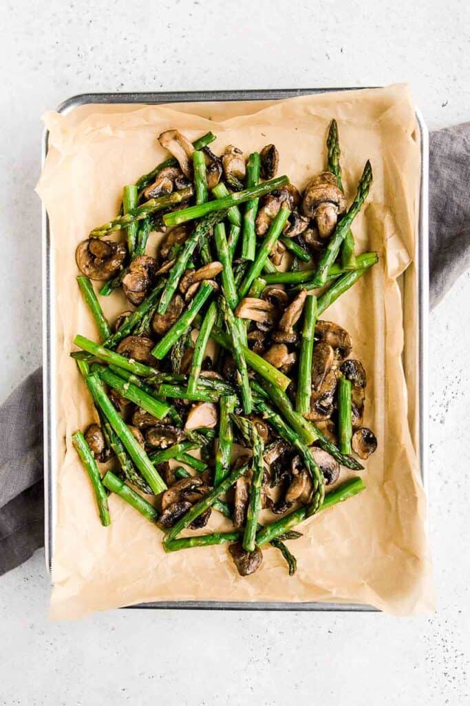 Roasted garlic asparagus and mushrooms is a simple vegan sheet pan side dish that‘s easy to make, flavorful and delicious. Serve with your favorite protein. | aheadofthyme.com