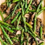 Roasted garlic asparagus and mushrooms is a simple vegan sheet pan side dish that‘s easy to make, flavorful and delicious. Serve with your favorite protein. | aheadofthyme.com