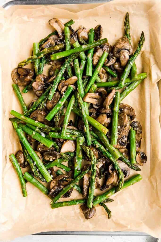 Roasted garlic asparagus and mushrooms is a simple vegan sheet pan side dish that‘s easy to make, flavorful and delicious. Serve with your favorite protein. | aheadofthyme.com