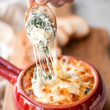 Warm, rich, creamy baked spinach dip is a delicious and easy appetizer that is baked until warm and melty. Easy to make ahead and a total crowd pleaser. | aheadofthyme.com