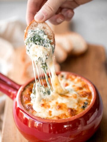 Warm, rich, creamy baked spinach dip is a delicious and easy appetizer that is baked until warm and melty. Easy to make ahead and a total crowd pleaser. | aheadofthyme.com