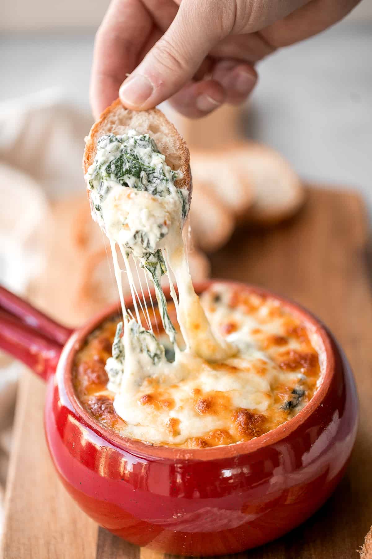 Warm, rich, creamy baked spinach dip is a delicious and easy appetizer that is baked until warm and melty. Easy to make ahead and a total crowd pleaser. | aheadofthyme.com