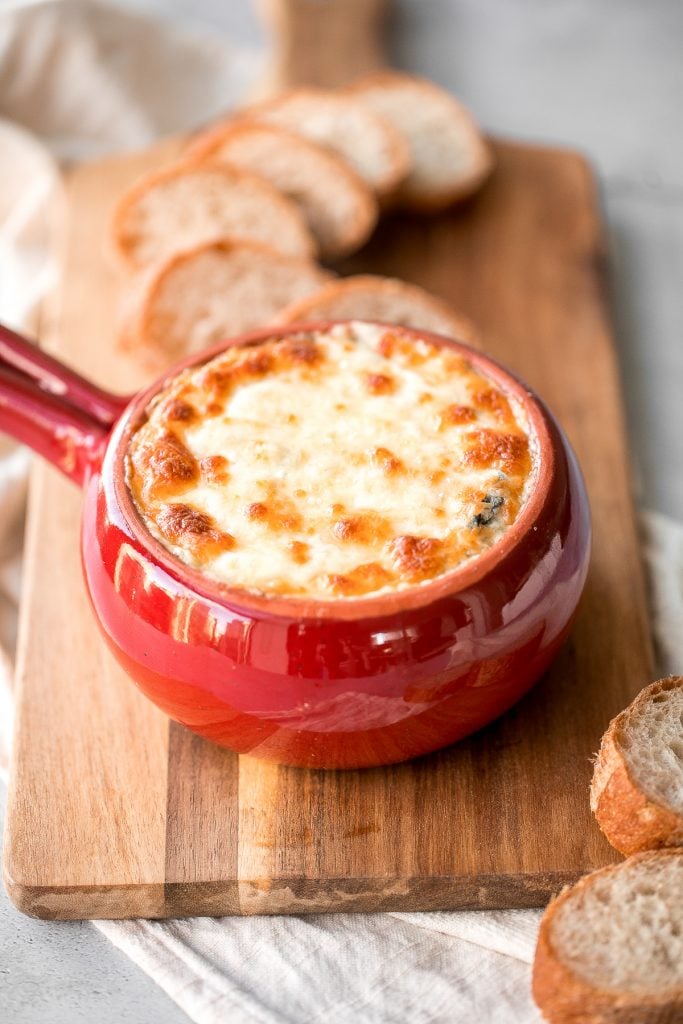 Warm, rich, creamy baked spinach dip is a delicious and easy appetizer that is baked until warm and melty. Easy to make ahead and a total crowd pleaser. | aheadofthyme.com