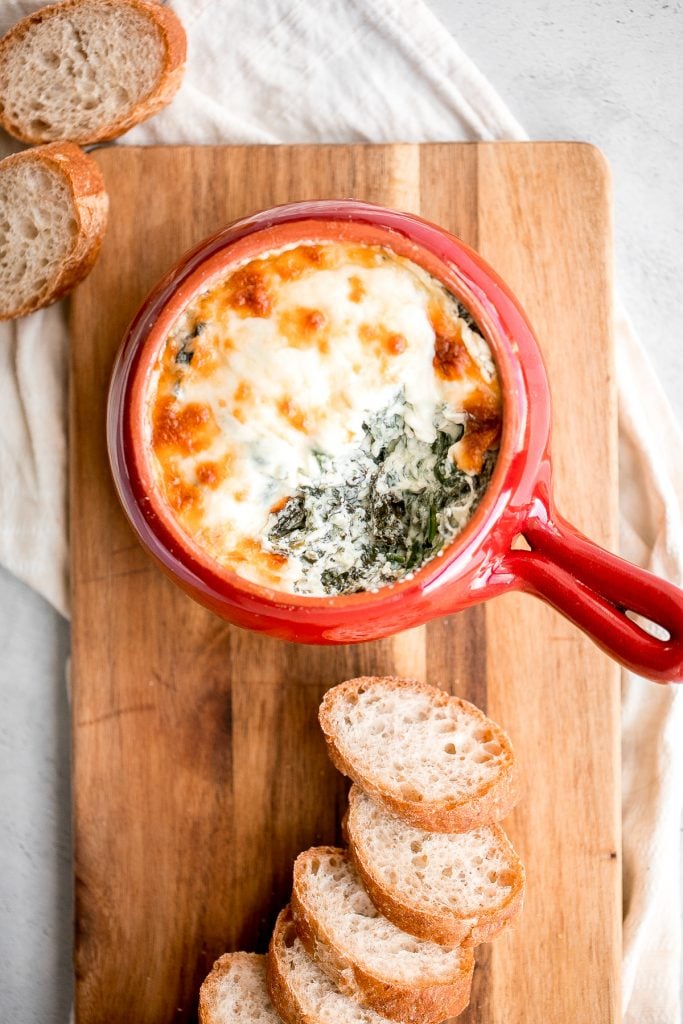 Warm, rich, creamy baked spinach dip is a delicious and easy appetizer that is baked until warm and melty. Easy to make ahead and a total crowd pleaser. | aheadofthyme.com