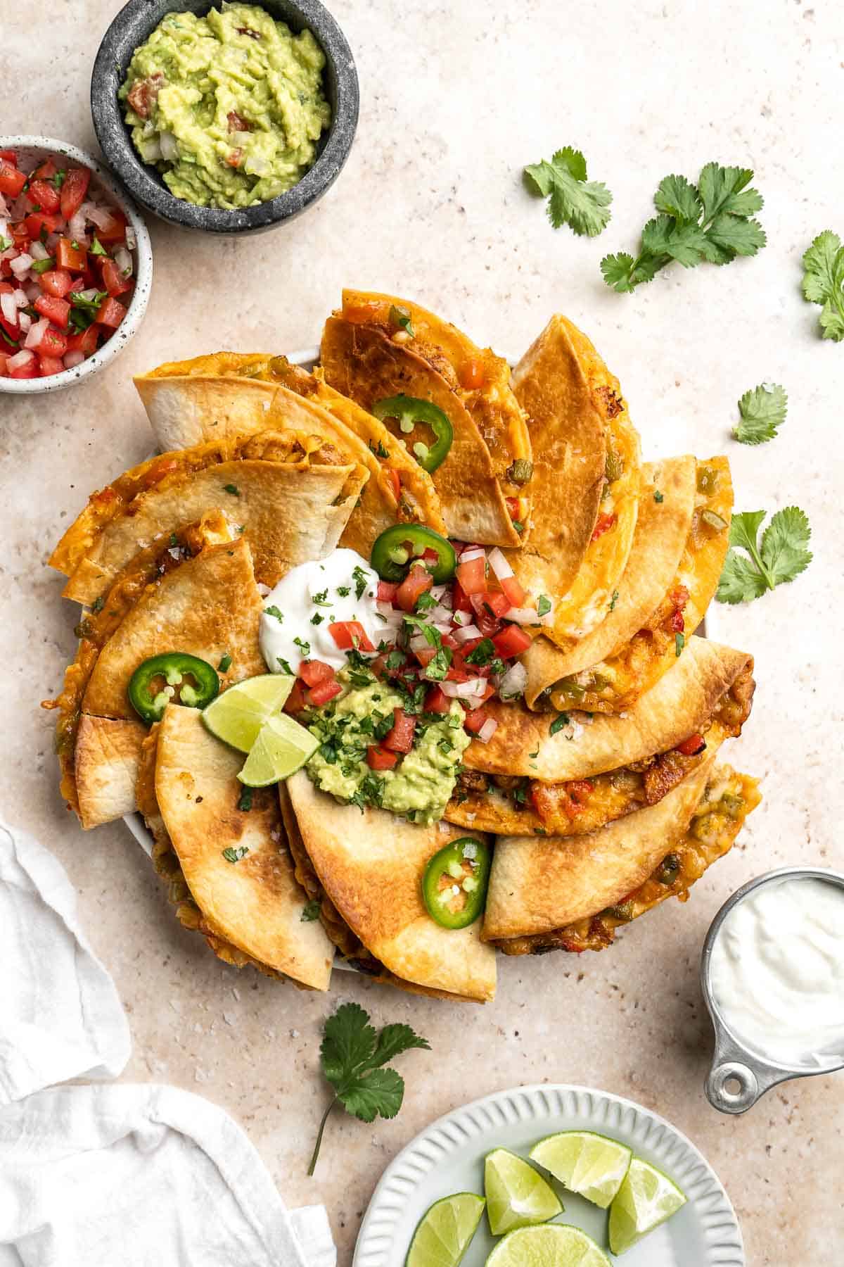 Baked Chicken Quesadillas are cheesy, crispy, flavorful, and delicious. This family-friendly recipe is quick and easy to make in just 30 minutes! | aheadofthyme.com