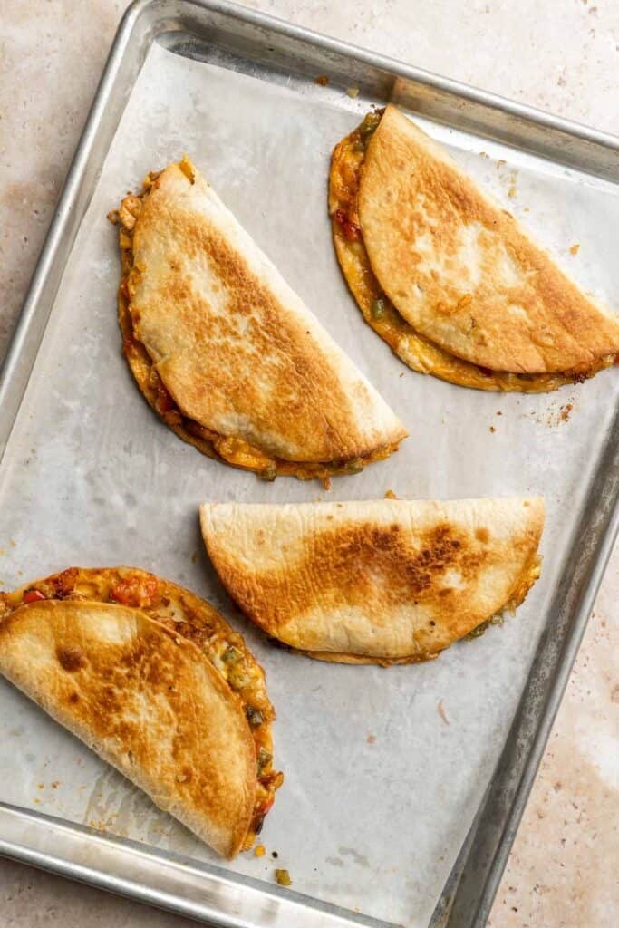 Baked Chicken Quesadillas are cheesy, crispy, flavorful, and delicious. This family-friendly recipe is quick and easy to make in just 30 minutes! | aheadofthyme.com