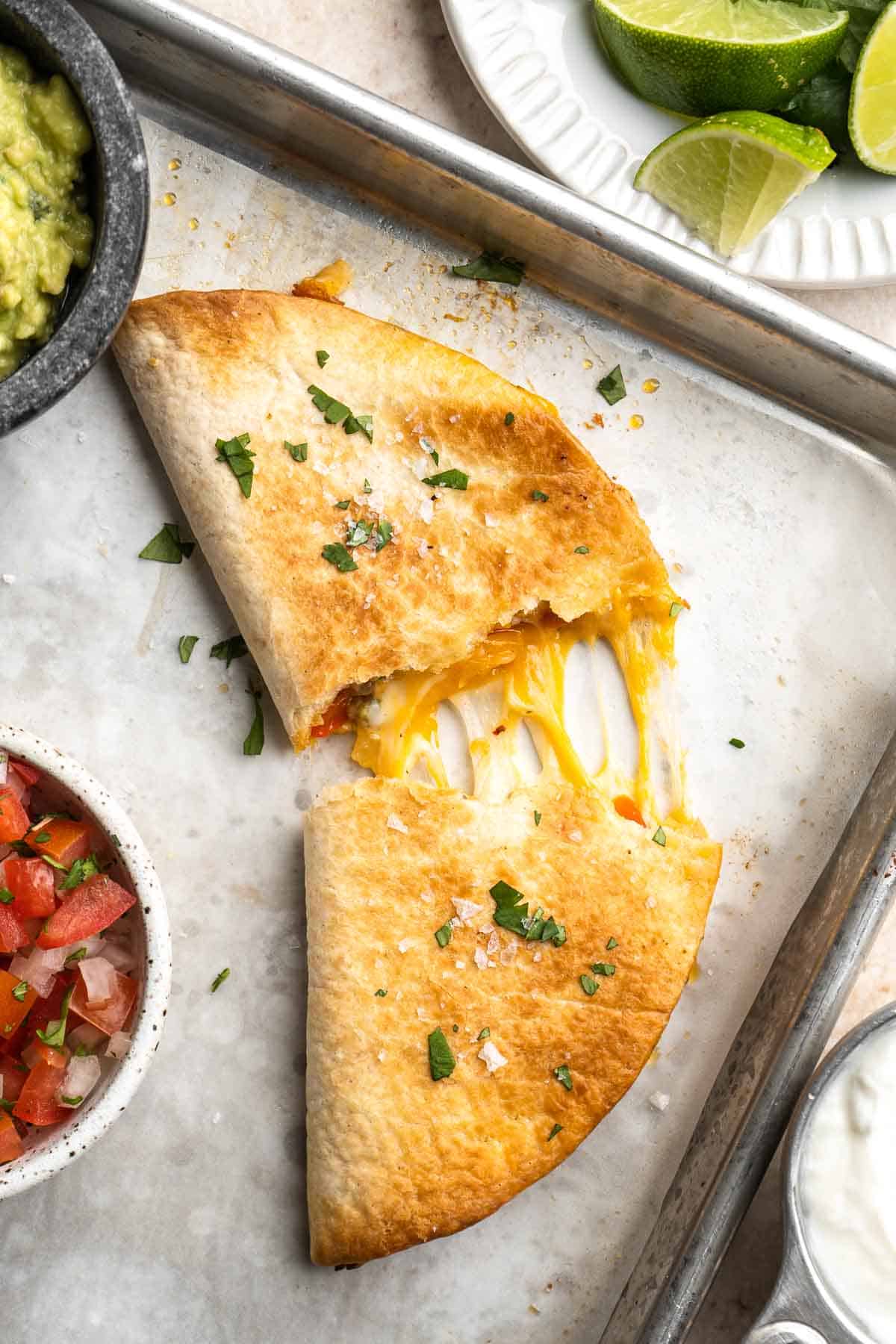 Baked Chicken Quesadillas are cheesy, crispy, flavorful, and delicious. This family-friendly recipe is quick and easy to make in just 30 minutes! | aheadofthyme.com