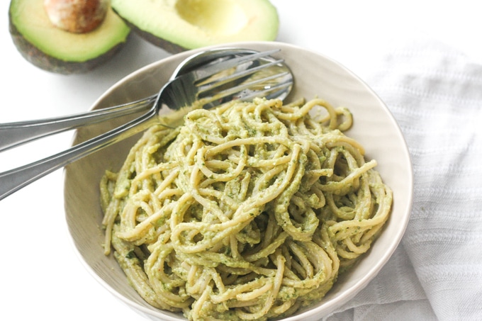 This easy 10-minute vegan light and creamy avocado basil pesto spaghetti is loaded with avocado, basil, walnuts, garlic, olive oil and lemon juice. | aheadofthyme.com