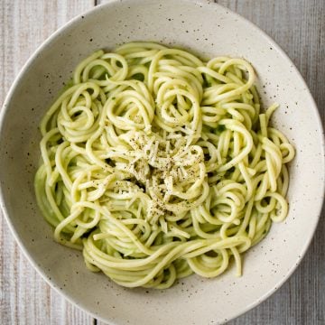 This easy 10-minute vegan light and creamy avocado basil pesto spaghetti is loaded with avocado, basil, walnuts, garlic, olive oil and lemon juice. | aheadofthyme.com