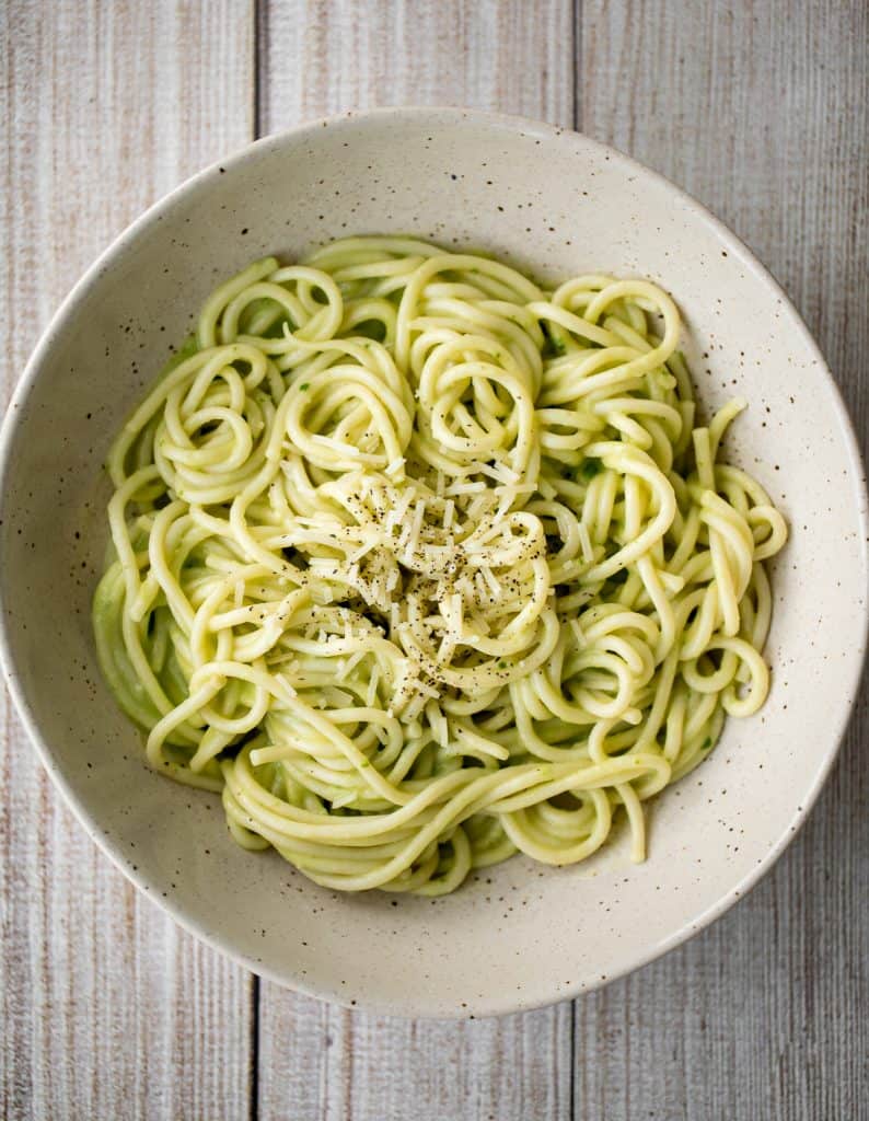 This easy 10-minute vegan light and creamy avocado basil pesto spaghetti is loaded with avocado, basil, walnuts, garlic, olive oil and lemon juice. | aheadofthyme.com