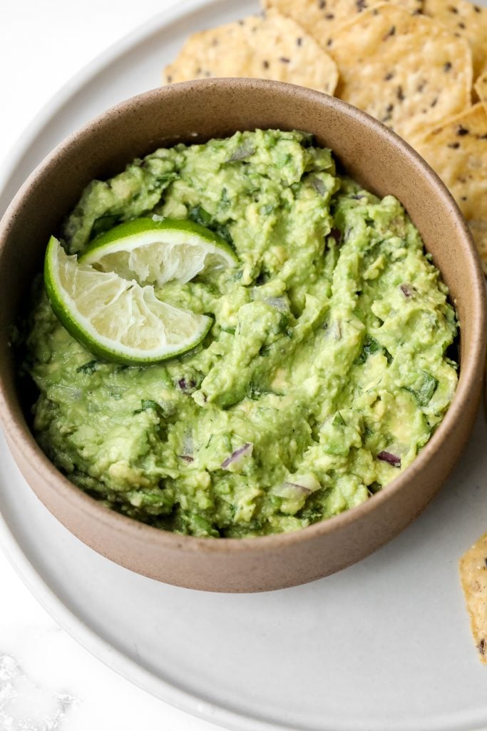 Delicious and easy guacamole is simple to make with just a few fresh ingredients in 5 minutes. This popular authentic Mexican dip is a total crowd-pleaser. | aheadofthyme.com