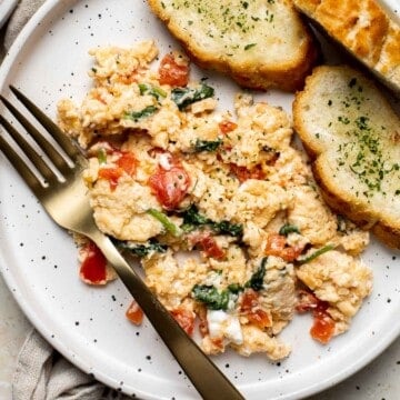 Mediterranean Scrambled Eggs with spinach, tomato, and feta is loaded with flavor and a quick and easy breakfast to make in under 10 minutes (with prep!). | aheadofthyme.com