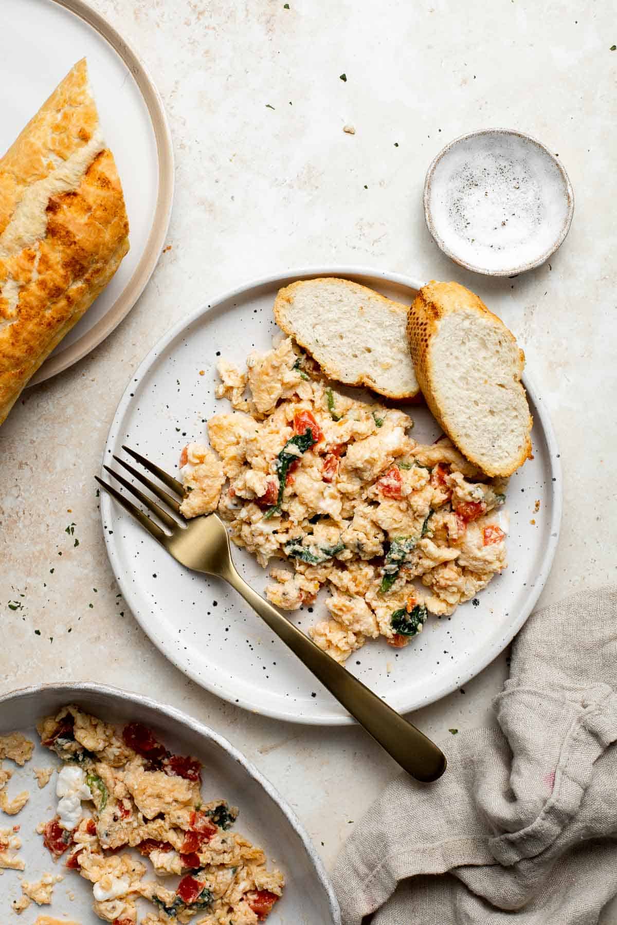 Mediterranean Scrambled Eggs with spinach, tomato, and feta is loaded with flavor and a quick and easy breakfast to make in under 10 minutes (with prep!). | aheadofthyme.com