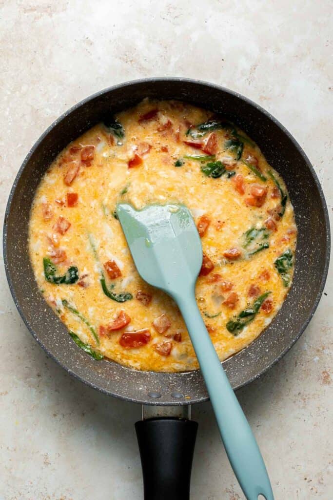 Mediterranean Scrambled Eggs with spinach, tomato, and feta is loaded with flavor and a quick and easy breakfast to make in under 10 minutes (with prep!). | aheadofthyme.com