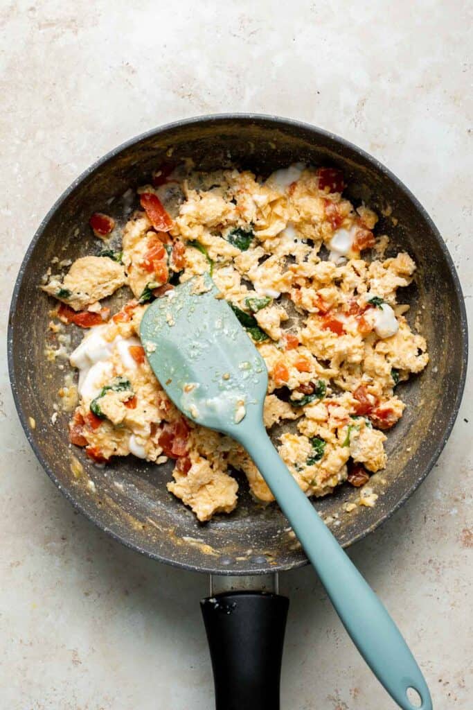 Mediterranean Scrambled Eggs with spinach, tomato, and feta is loaded with flavor and a quick and easy breakfast to make in under 10 minutes (with prep!). | aheadofthyme.com