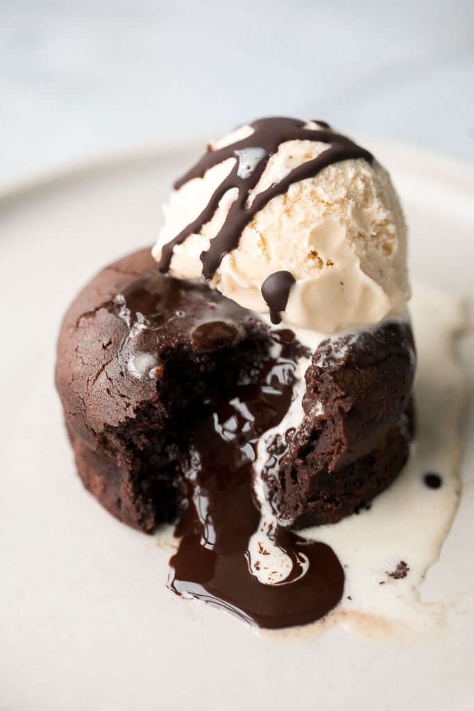 Molten chocolate lava cakes are rich and fudgy with a classic gooey chocolate center that flows out like lava. So simple and easy to make. | aheadofthyme.com