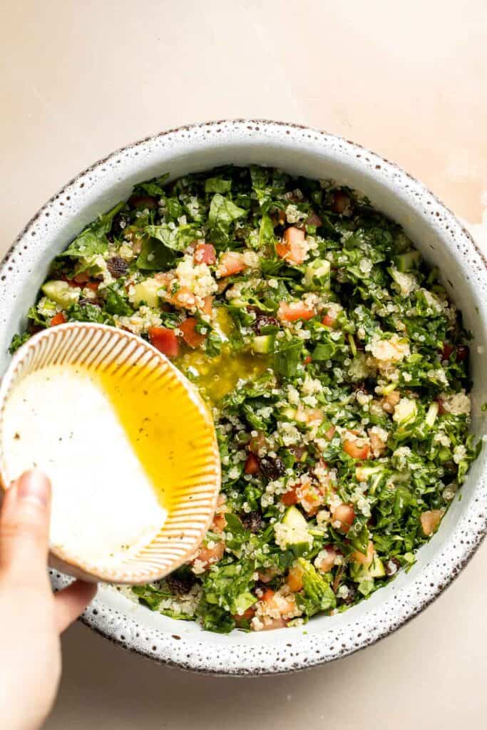 Quinoa Spinach Power Salad is made with tender quinoa, tomatoes, cucumbers, and raisins dressed in a homemade lemon vinaigrette. Gluten-free and vegan too. | aheadofthyme.com