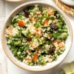 Quinoa Spinach Power Salad is made with tender quinoa, tomatoes, cucumbers, and raisins dressed in a homemade lemon vinaigrette. Gluten-free and vegan too. | aheadofthyme.com
