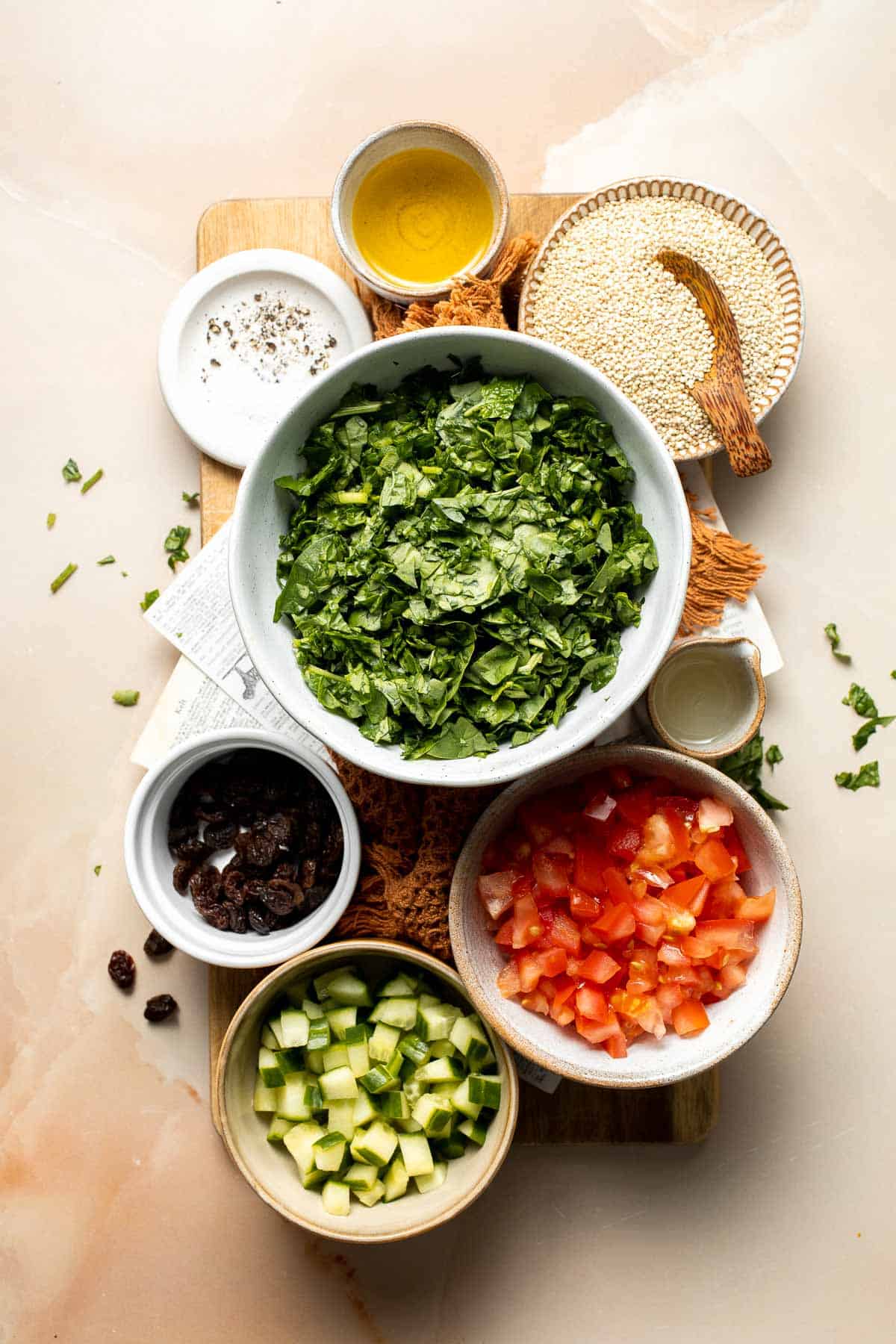 Quinoa Spinach Power Salad is made with tender quinoa, tomatoes, cucumbers, and raisins dressed in a homemade lemon vinaigrette. Gluten-free and vegan too. | aheadofthyme.com
