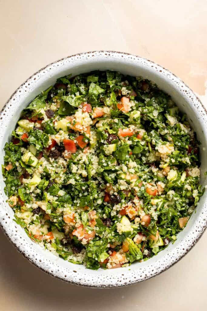Quinoa Spinach Power Salad is made with tender quinoa, tomatoes, cucumbers, and raisins dressed in a homemade lemon vinaigrette. Gluten-free and vegan too. | aheadofthyme.com