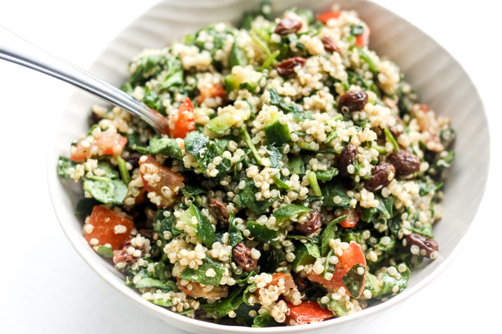 Take a bite into this refreshing, gluten-free quinoa spinach salad bursting with colourful tomatoes, cucumbers and raisins dressed with a lemon vinaigrette.