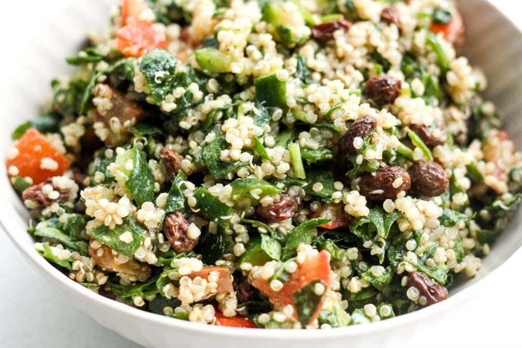 Take a bite into this refreshing, gluten-free quinoa spinach salad bursting with colourful tomatoes, cucumbers and raisins dressed with a lemon vinaigrette.