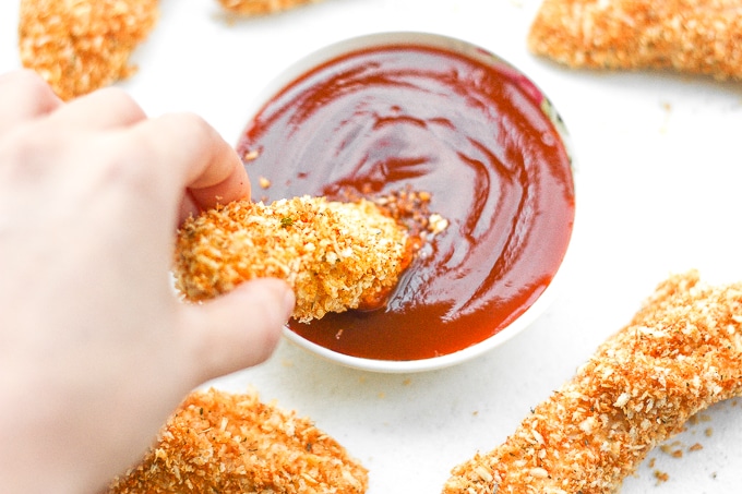 Baked Crispy Chicken Strips: Juicy long strips of chicken shaped perfectly for dipping and coated with a flawless crispy and crunchy exterior, baked crispy chicken strips are a pleaser | aheadofthyme.com