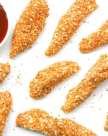 Baked Crispy Chicken Strips: Juicy long strips of chicken shaped perfectly for dipping and coated with a flawless crispy and crunchy exterior, baked crispy chicken strips are a pleaser | aheadofthyme.com
