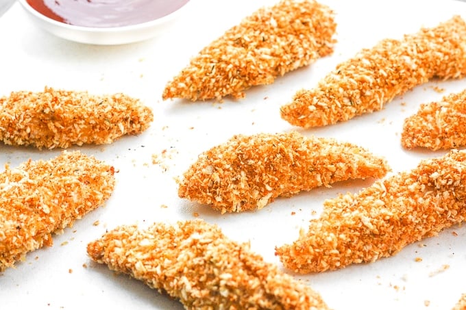 Baked Crispy Chicken Strips: Juicy long strips of chicken shaped perfectly for dipping and coated with a flawless crispy and crunchy exterior, baked crispy chicken strips are a pleaser | aheadofthyme.com