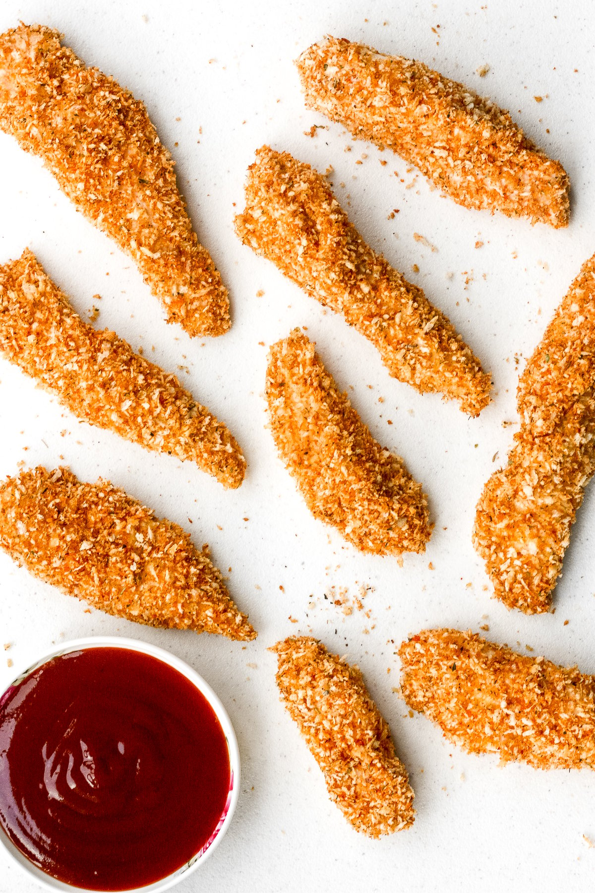 Juicy long strips of chicken shaped perfectly for dipping and coated with a flawless crispy and crunchy exterior, baked crispy chicken strips are a pleaser. | aheadofthyme.com