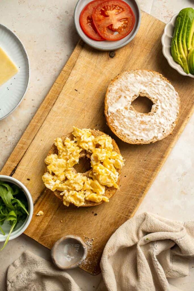With layers of scrambled eggs, melty cheese, fresh tomato, creamy avocado, and peppery arugula, this Breakfast Bagel is a perfect way to start your day. | aheadofthyme.com