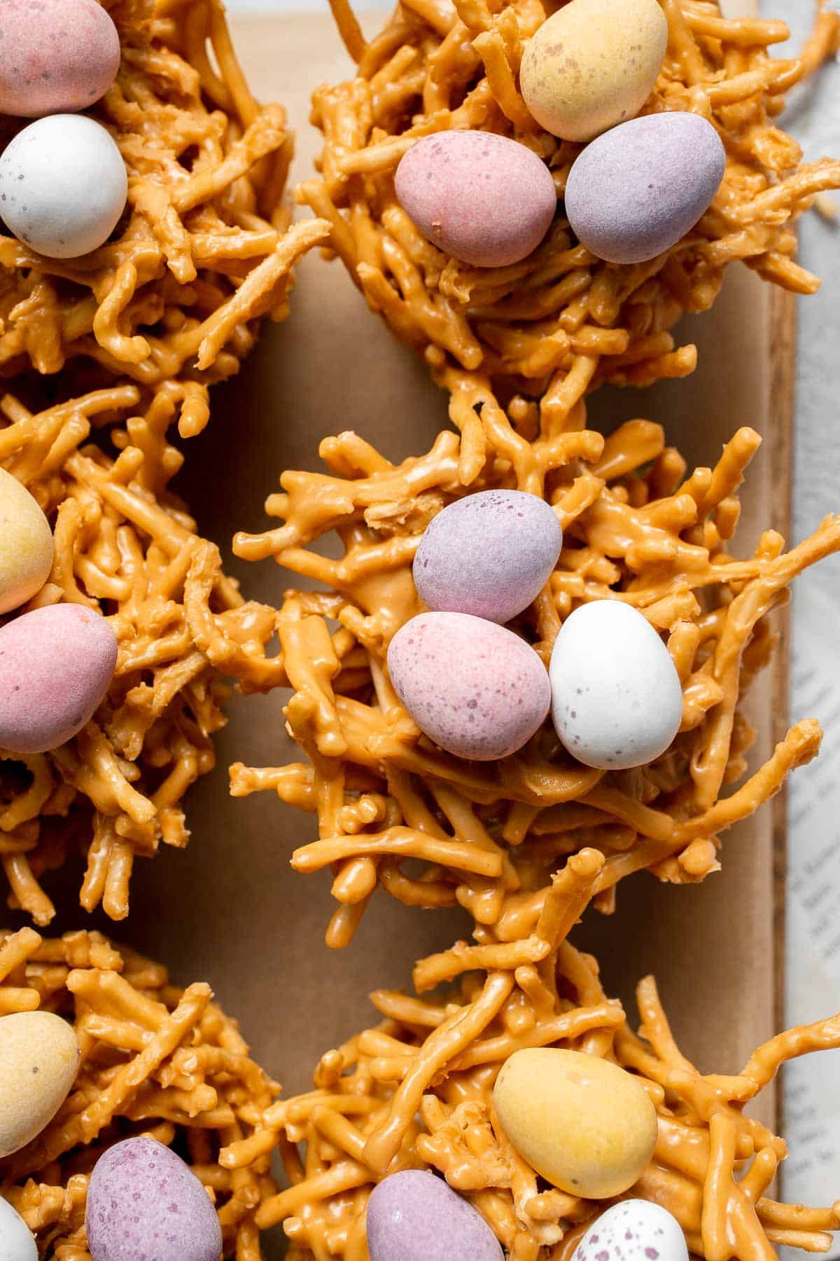 No Bake Bird's Nest Cookies are a fun and festive Easter treat made with butterscotch and peanut butter mixture and topped with chocolate mini eggs. | aheadofthyme.com
