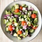 The perfect Greek salad with fresh tomatoes, cucumbers, red onions, green peppers, romaine lettuce, olives and feta cheese tossed in a lemon vinaigrette. | aheadofthyme.com