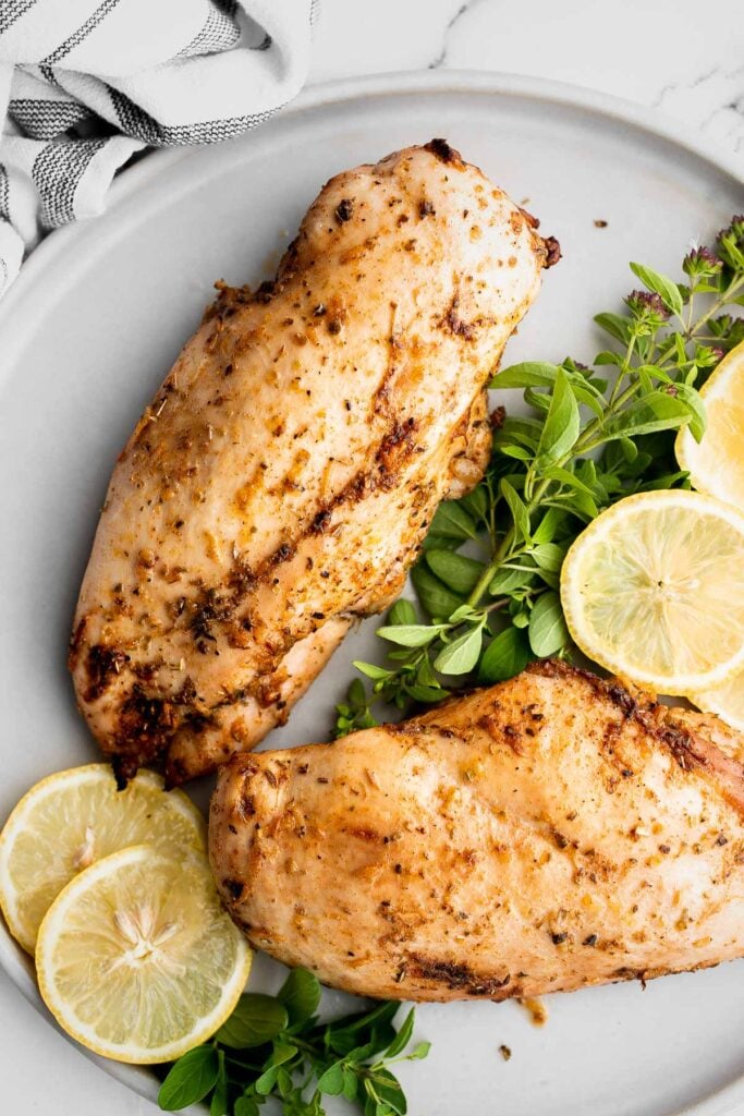 Juicy, tender, and moist, baked chicken breast with the best Greek souvlaki marinade is the most flavorful and delicious chicken dinner in under 30 minutes. | aheadofthyme.com