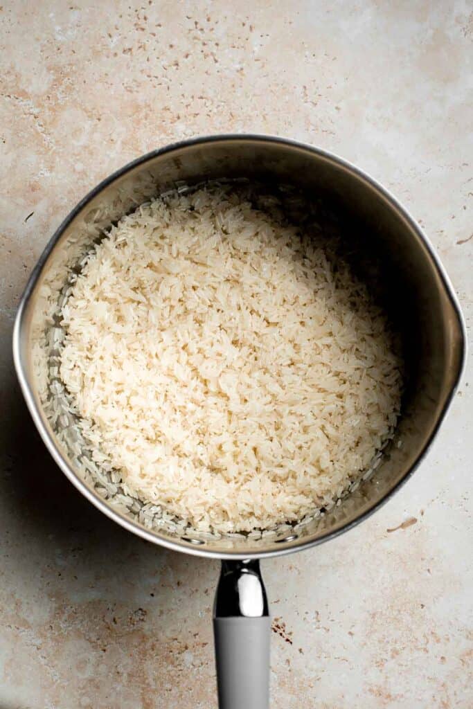 Easy coconut rice is light, fluffy, delicious, and flavorful. It's a quick and easy side dish that compliments all Thai, South Asian, and tropical dishes. | aheadofthyme.com