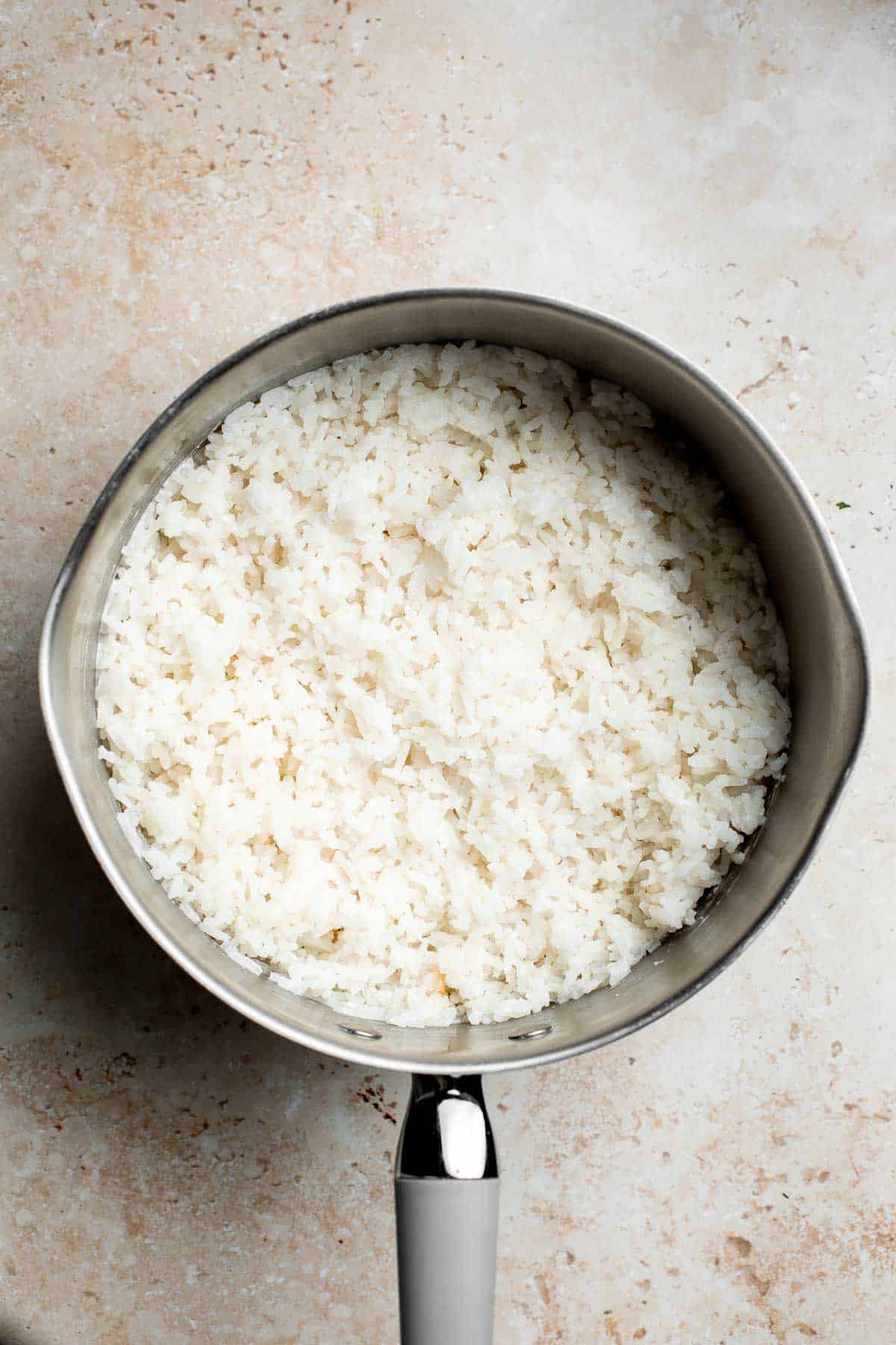 Easy coconut rice is light, fluffy, delicious, and flavorful. It's a quick and easy side dish that compliments all Thai, South Asian, and tropical dishes. | aheadofthyme.com