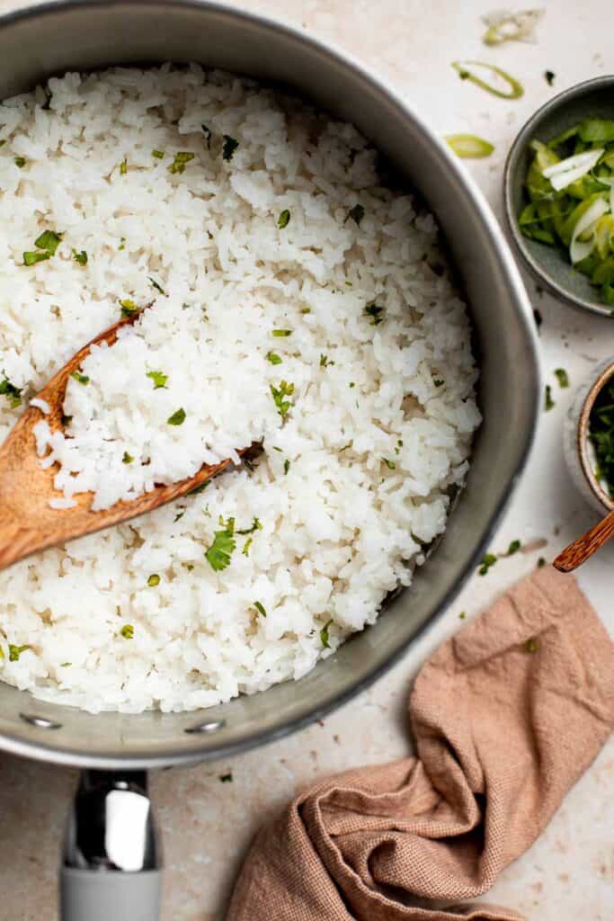 Easy coconut rice is light, fluffy, delicious, and flavorful. It's a quick and easy side dish that compliments all Thai, South Asian, and tropical dishes. | aheadofthyme.com