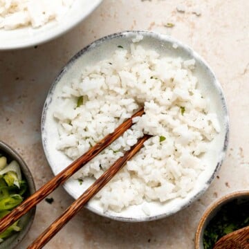 Easy coconut rice is light, fluffy, delicious, and flavorful. It's a quick and easy side dish that compliments all Thai, South Asian, and tropical dishes. | aheadofthyme.com