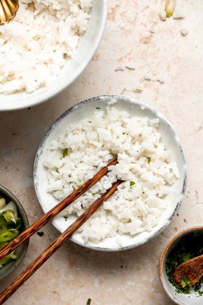 Easy coconut rice is light, fluffy, delicious, and flavorful. It's a quick and easy side dish that compliments all Thai, South Asian, and tropical dishes. | aheadofthyme.com