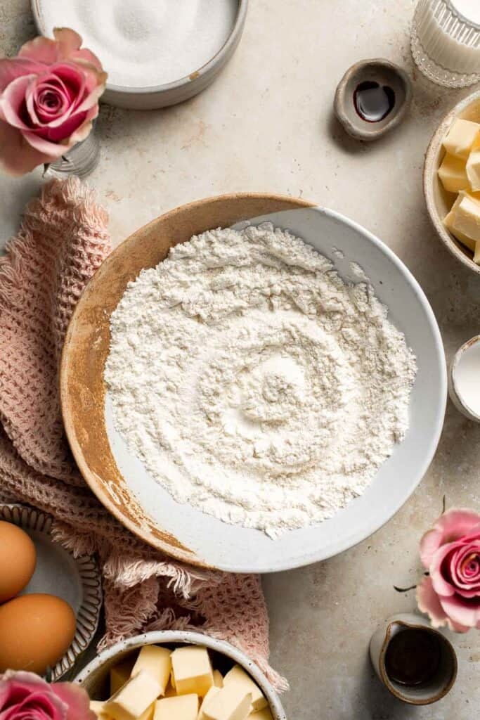 This Mother’s Day, treat someone special (or yourself!) to these beautifully light, airy, and fluffy Vanilla Cupcakes with Rose Petal Buttercream. | aheadofthyme.com