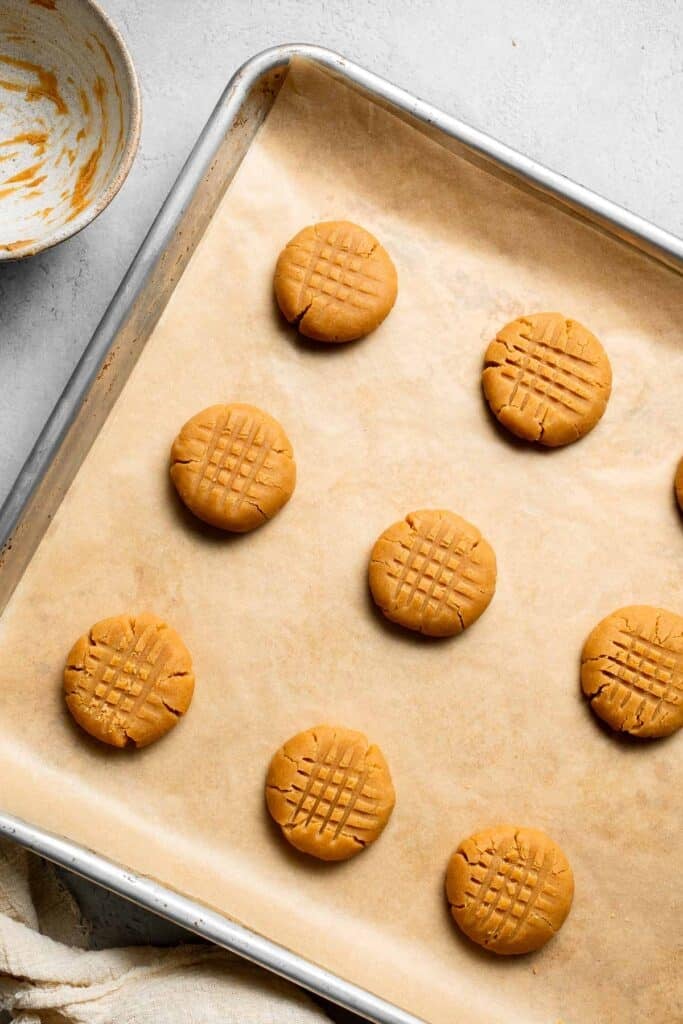 The BEST Soft and Chewy Peanut Butter Cookies are thick, puffy, and melt-in-your-mouth good. Easy to make in under 20 minutes — and they stay soft for days! | aheadofthyme.com