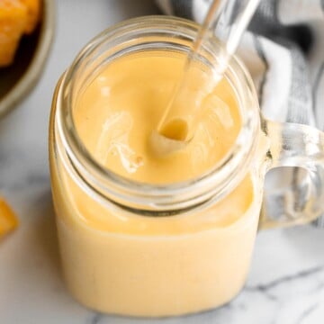 Healthy mango yogurt smoothie is refreshing, delicious, and healthy. Loaded with tropical mangos and low-fat yogurt, it's the perfect breakfast on the go. | aheadofthyme.com